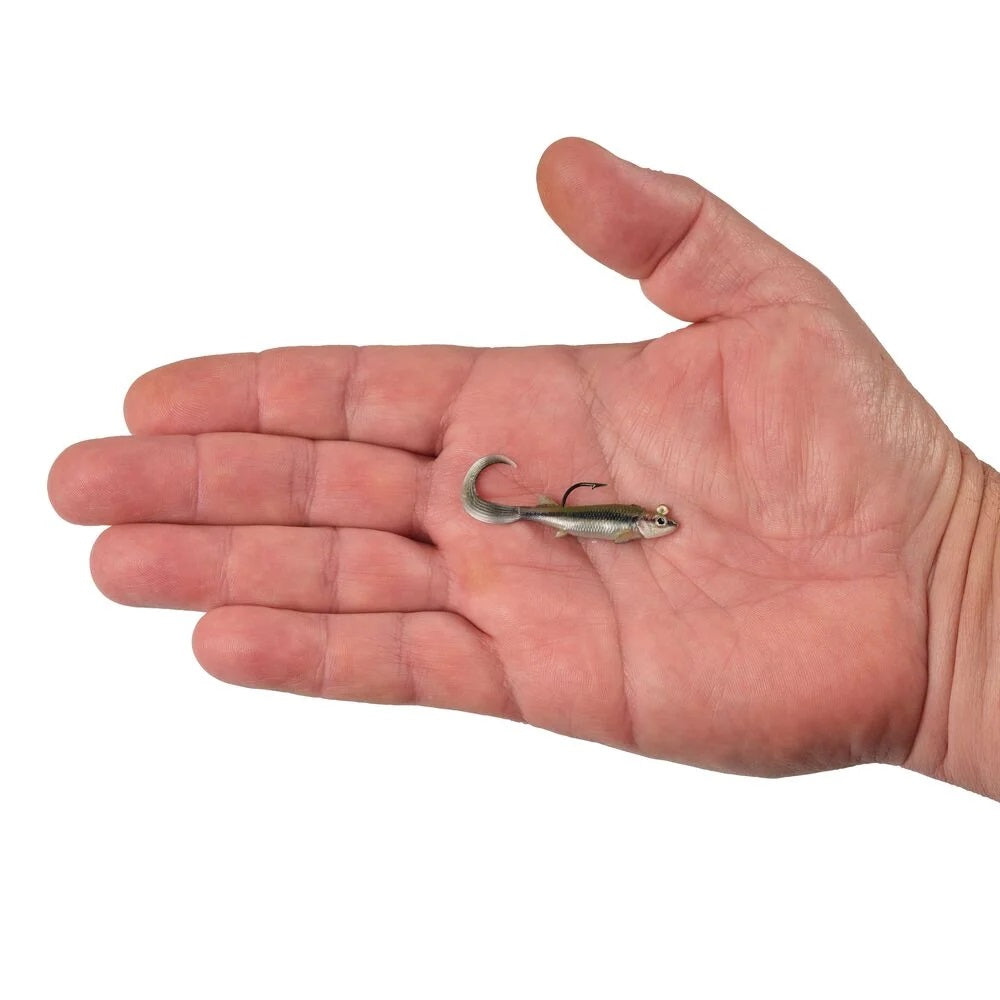 A hand holding a 2 inch Berkley PowerBait Minnotator Grub that is green and black with a white belly.